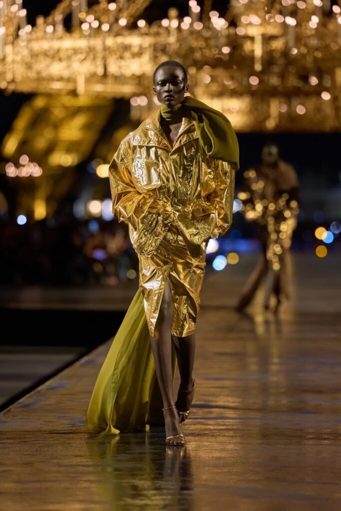 Saint Laurent Spring 2027 by Anthony Vaccarello turns Paris gold with glamorous tailoring, liquid dresses, safari references and a decade of Saint Laurent style.