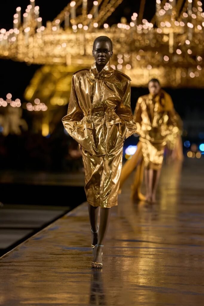 Saint Laurent Spring 2027 by Anthony Vaccarello turns Paris gold with glamorous tailoring, liquid dresses, safari references and a decade of Saint Laurent style.