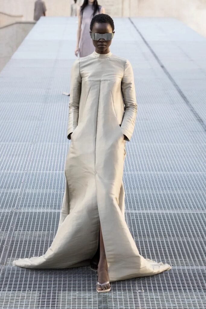 Rick Owens Spring 2027 Ready-to-Wear explores sculptural silhouettes, dark glamour, dramatic proportions and the designer’s futuristic fashion language.